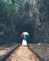 Rear view of woman walking on footpath