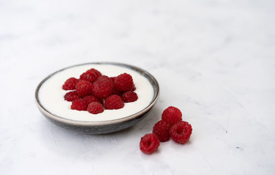 High angle view of strawberries in plate on table