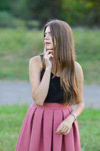 Midsection of woman standing on field