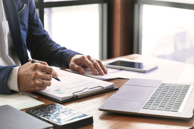 Low angle view of man using laptop on table