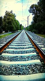 Railroad track with trees in background