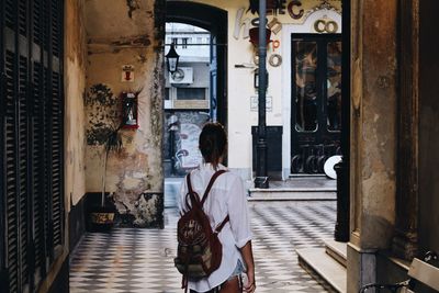 Rear view of woman standing on floor