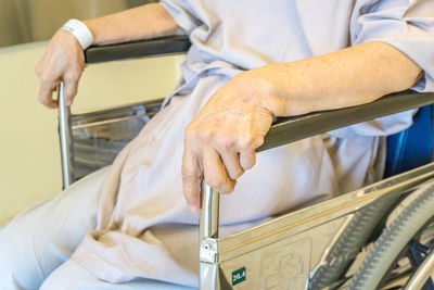 Midsection of man holding hands