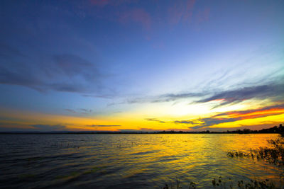 Scenic view of sea against romantic sky at sunset