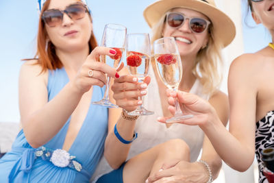 Smiling women toasting champagne