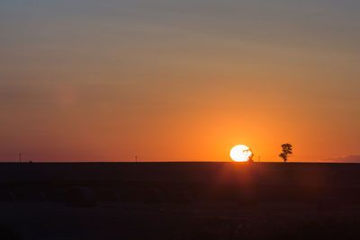 Silhouette landscape against sky during sunset