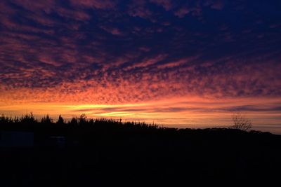 Scenic view of silhouette landscape against romantic sky at sunset