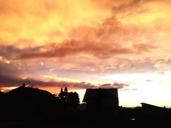 Silhouette of built structure against dramatic sky