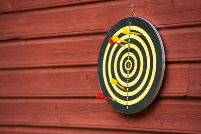 Close-up of antique hanging on wooden wall