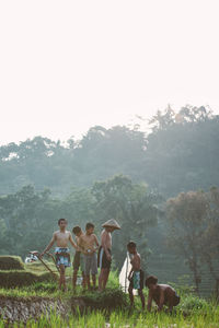 People on field against clear sky