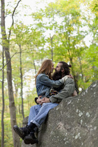 Young couple hanging out in the forest