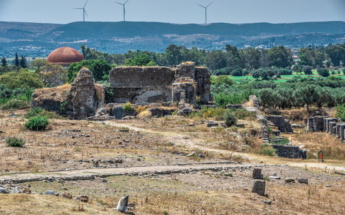 Built structure on landscape against the sky