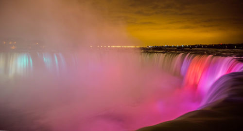 Scenic view of illuminated niagara falls against sky at night