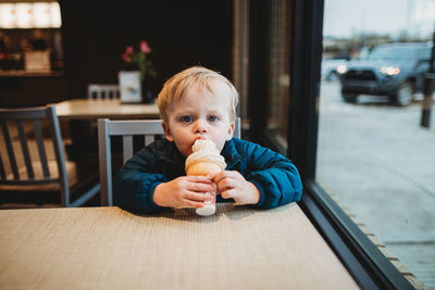 Young boy eating ice cream cone