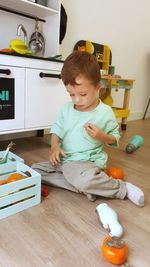 High angle view of boy playing with toys on table