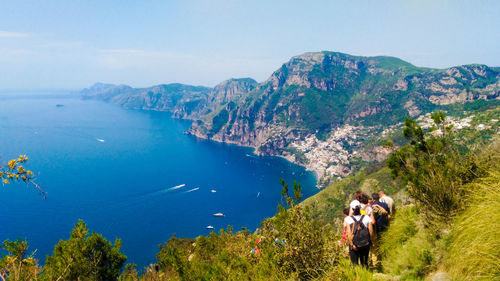 Panoramic view of people on mountain against sky