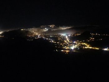 High angle view of city lit up at night