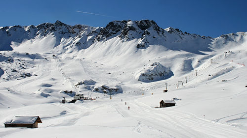 Ski lift on snow covered landscape