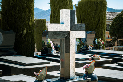 Black and white granite cross on a grave in the cemetery.