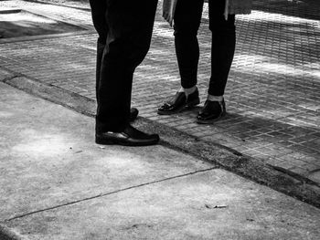 Low section of people walking on street