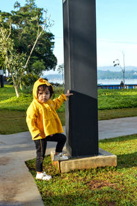 Full length portrait of boy standing in park