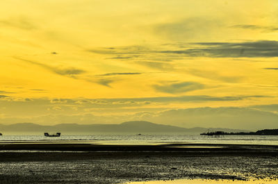 Scenic view of beach against sky during sunset