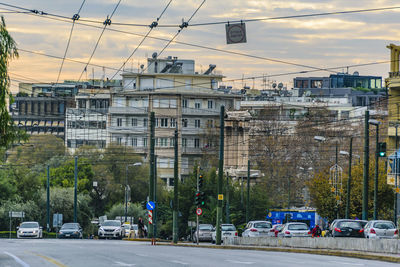 Vehicles on road against buildings in city