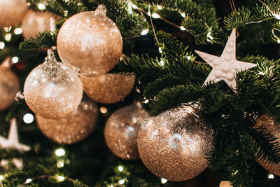 Magic cozy details, festive winter background. christmas tree decorated with golden christmas balls