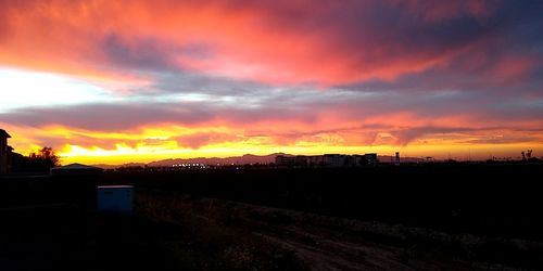 Scenic view of silhouette field against sky during sunset