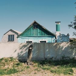 Abandoned house on field against clear sky