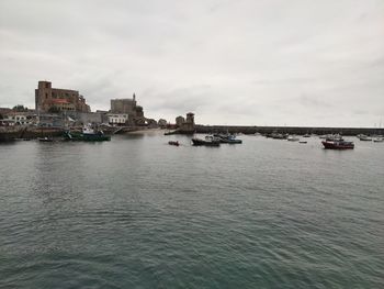 Scenic view of sea against buildings in city