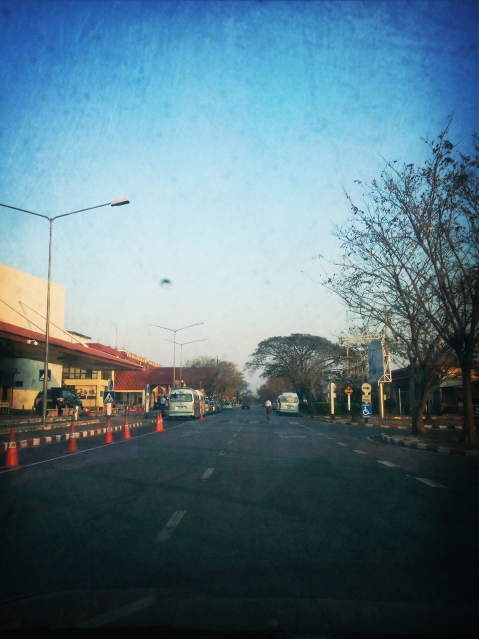 transportation, road, the way forward, car, street, road marking, land vehicle, mode of transport, sky, street light, diminishing perspective, clear sky, tree, vanishing point, building exterior, dusk, blue, built structure, illuminated, asphalt