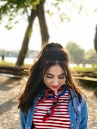 Beautiful young woman standing in park