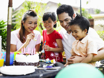 Family celebrating birthday in lawn