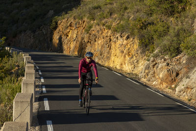 Man riding bicycle on road