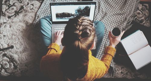 Rear view of woman using laptop 