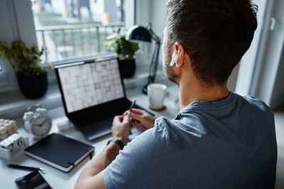 Man working remotely at home office, use laptop