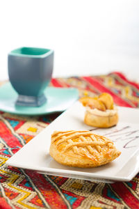Close-up of pastry and coffee cup
