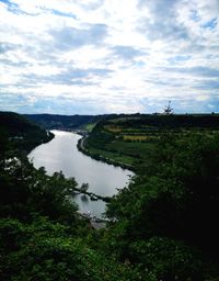 Scenic view of river amidst trees against sky