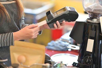 Midsection of woman working with coffee