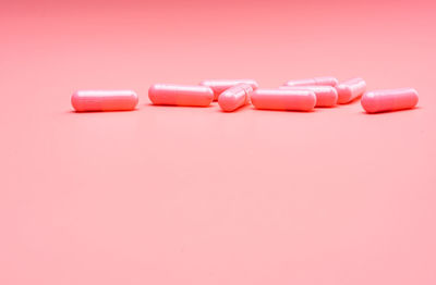 Close-up of colored pencils against pink background