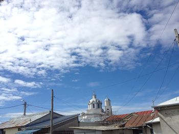 Low angle view of bridge and buildings against sky