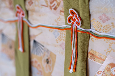 Close-up of decorations hanging on fabric