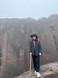 Rear view of man standing on mountain