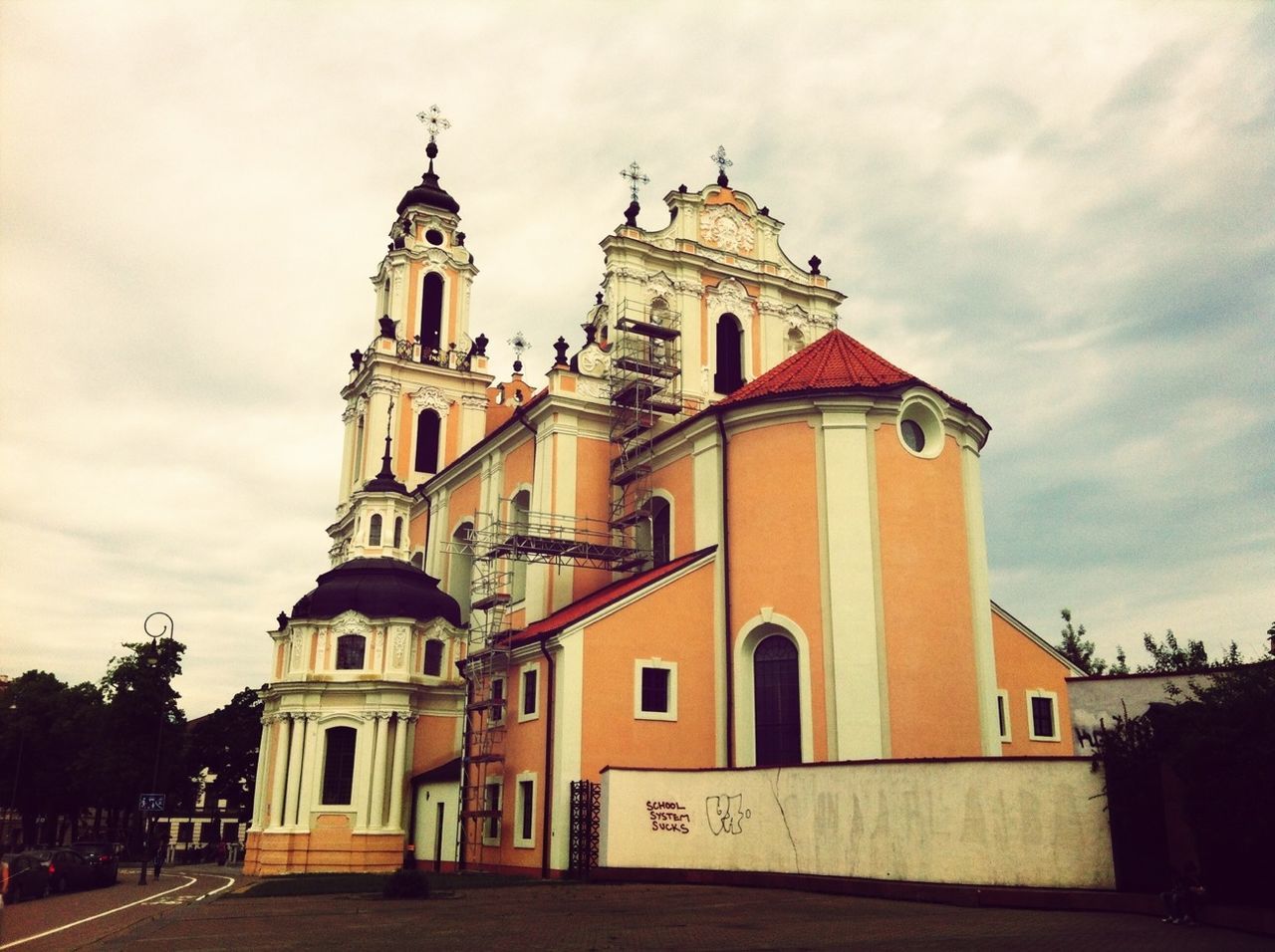 architecture, building exterior, built structure, church, place of worship, religion, spirituality, sky, low angle view, cloud - sky, cross, facade, dome, cloud, cathedral, outdoors, cloudy, exterior