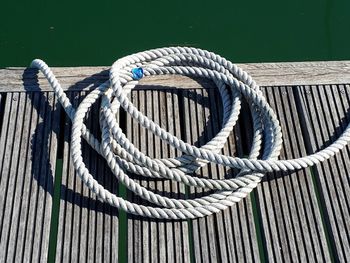 Close-up of rope tied on boat moored at harbor