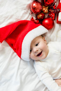 High angle view of cute baby girl sleeping on bed