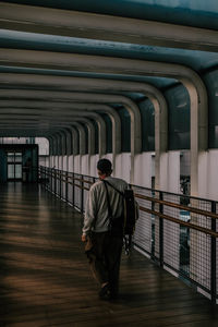 Rear view of man walking in building