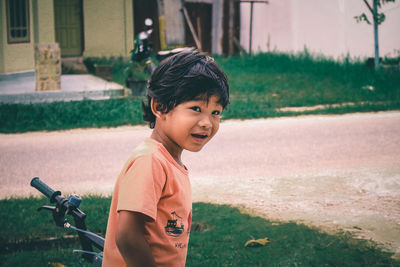 Portrait of cute boy standing outdoors