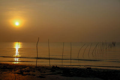 Scenic view of beach against sky during sunset